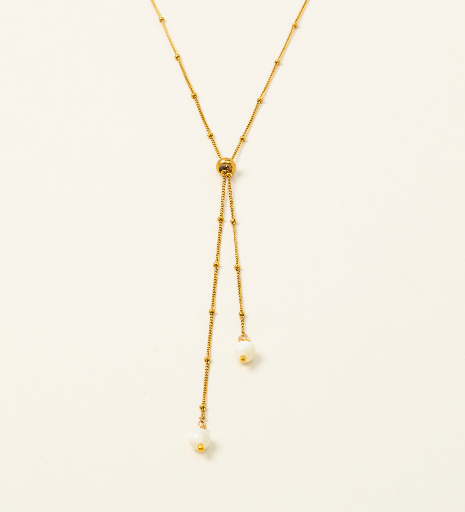 Collier Amalfi, chaîne satellite dorée forme Y et perles pierre de lune, fond crème